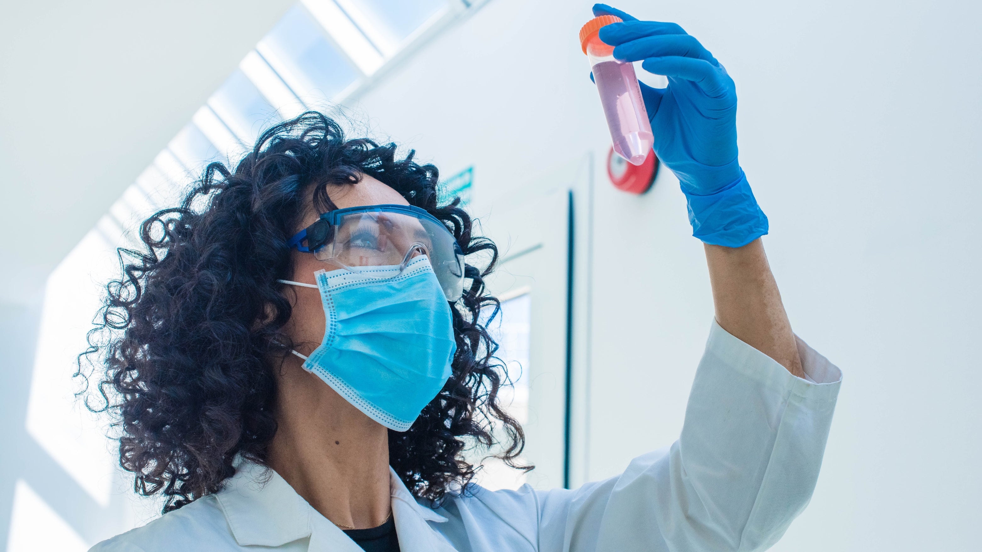 cientist pipetting defined cell culture media for stem cell research.
